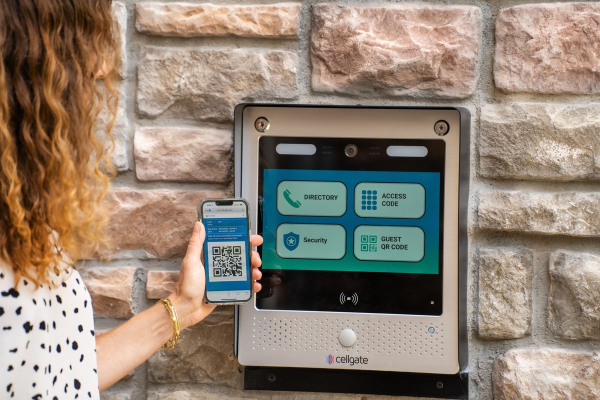 Resident entering an apartment community by scanning a QR code visitor pass at a CellGate Watchman WXL touchscreen entry unit